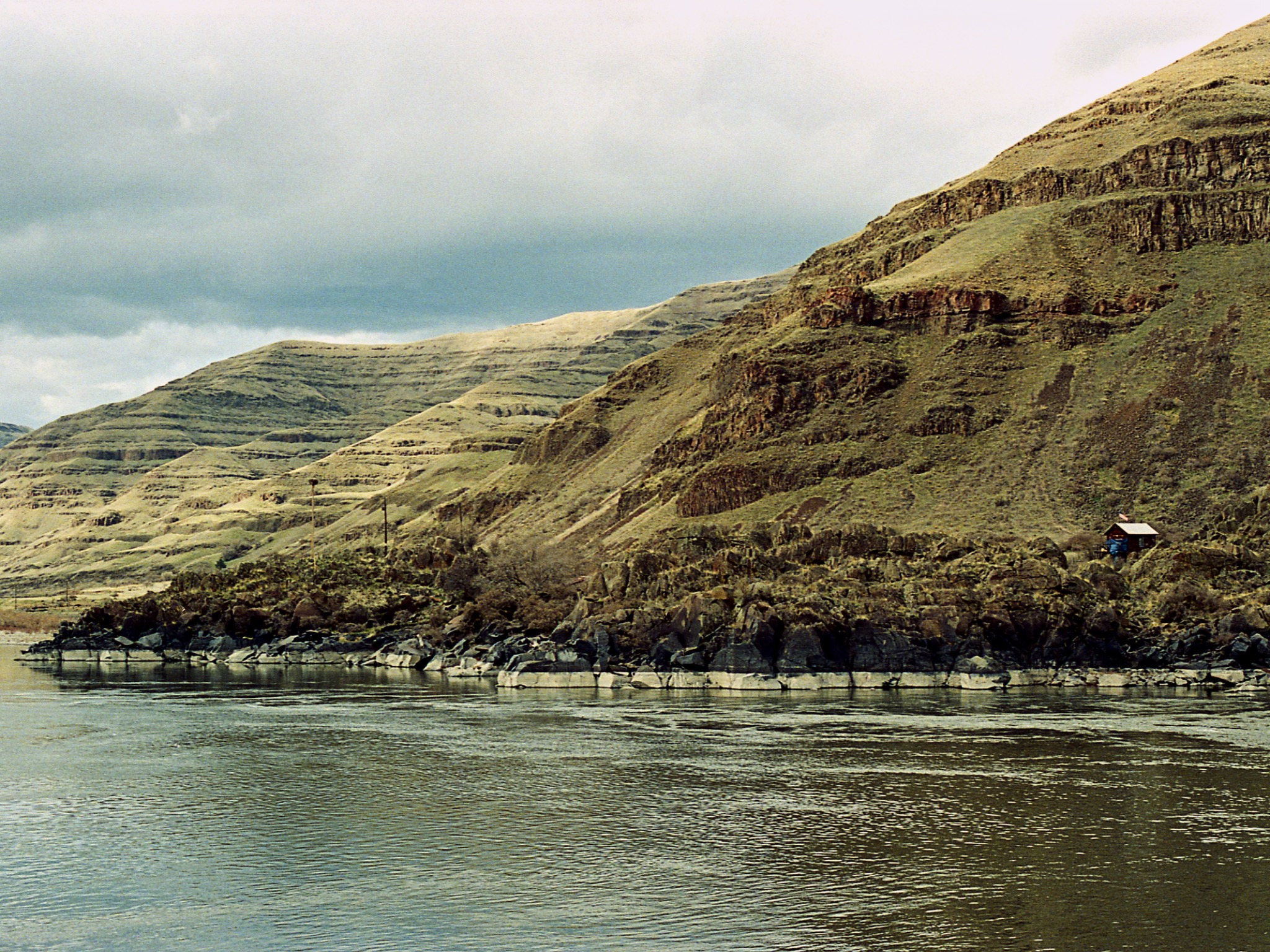 The Snake River beneath steep layered hills