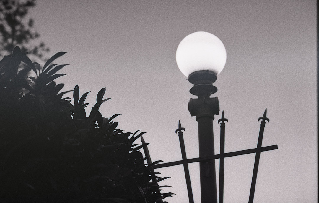 A glowing streetlamp against a dark sky