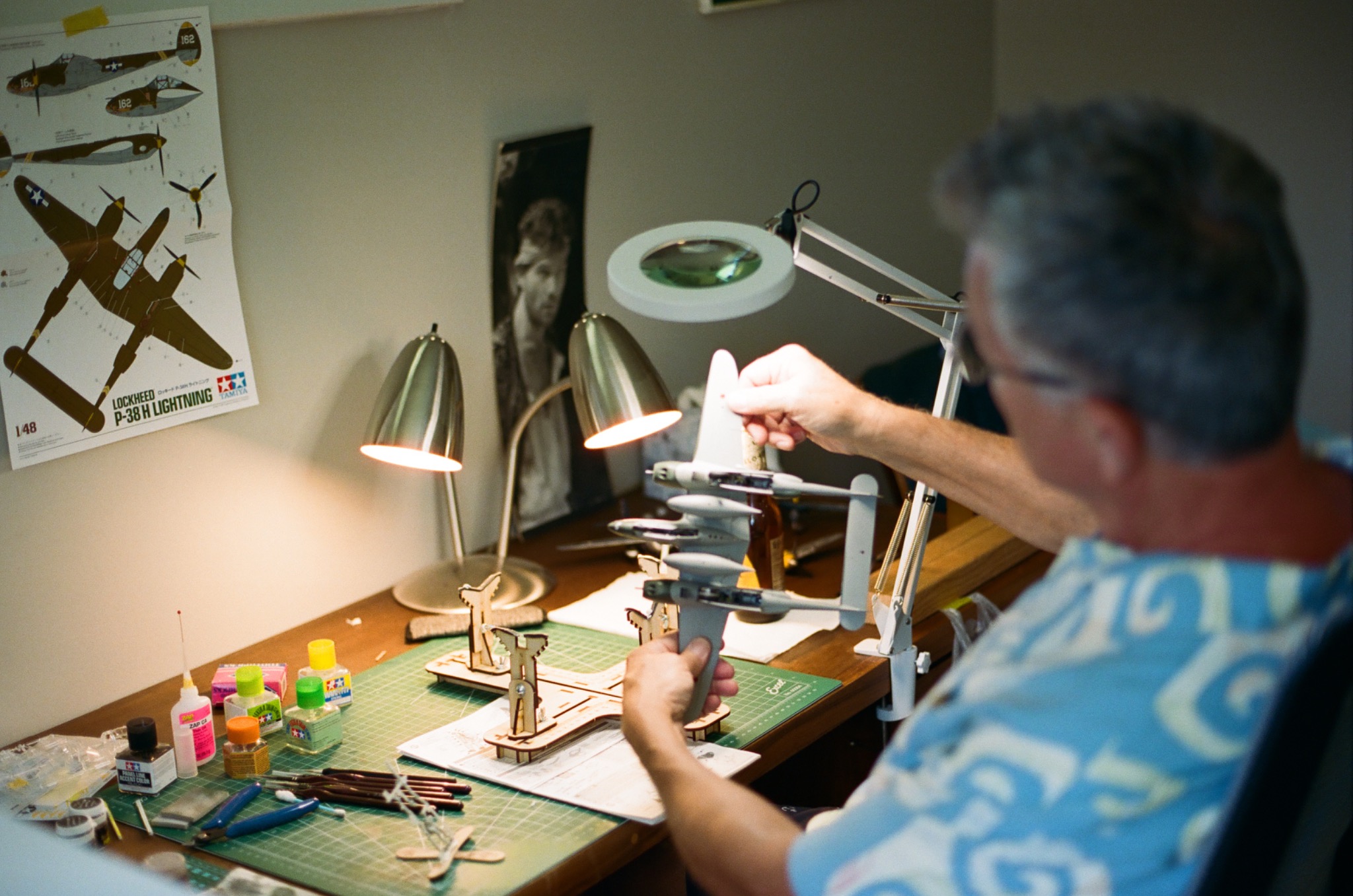 Hank working on a model airplane at his desk