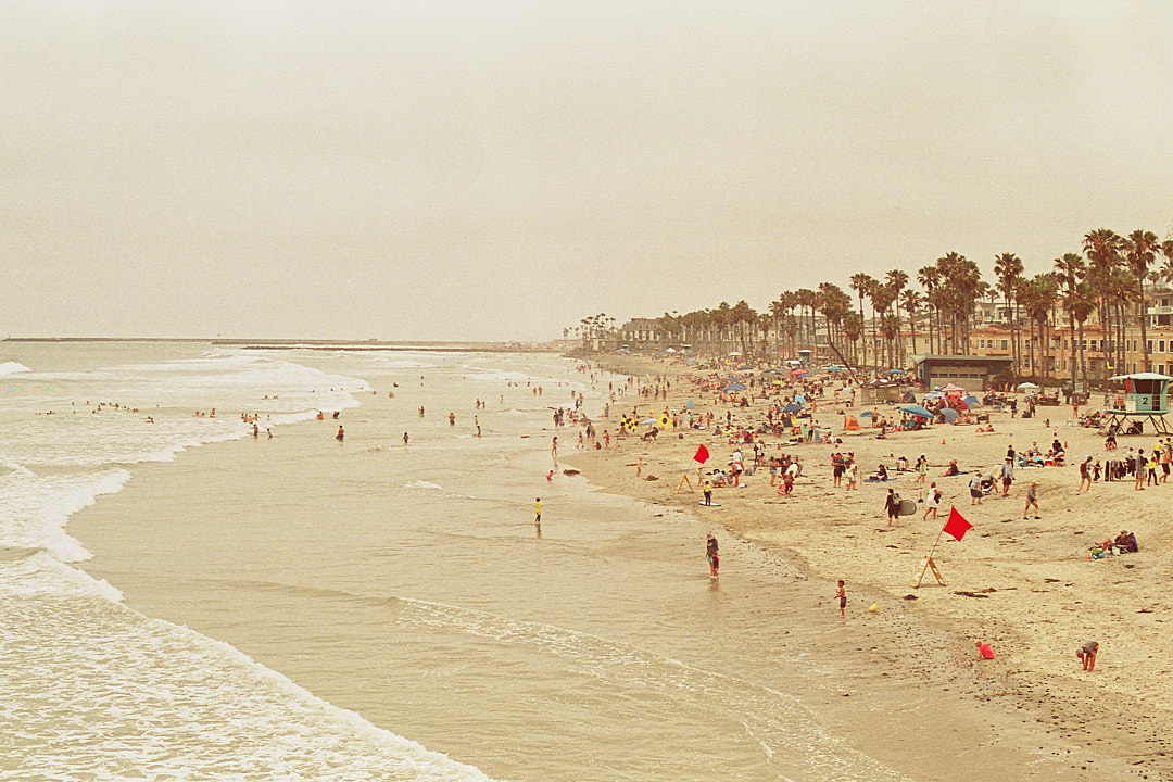 A crowded beach stretching along the San Diego coast